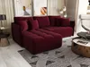 A modern living room with a dark red sectional sofa, coffee table, and artwork.