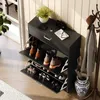 A shoe cabinet with multiple shelves and drawers, placed in a hallway next to a coat rack and an umbrella stand. Náhľad obrázku produktu