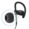 Close-up of a black earbud with a foam ear tip, highlighted by a blue circle. Produktbild-Vorschau