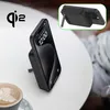 A black iPhone is propped up on a black wireless charger on a white table, next to a cup of coffee. Voir les images du produit
