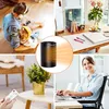 A collage of four images showing a personal heater in different settings: a father and child relaxing, a desk setup, a plant on a table with a remote, and a woman in a wheelchair working. Produktbild-Vorschau