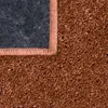 A close-up view of the corner of a rug, showing the texture of the carpet and the backing. Produktbild-Vorschau