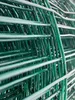 A close-up, abstract view of green wire mesh fencing, showing the texture and pattern of the material. Produktbild-Vorschau