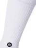 A close-up of a white sock with a black logo on the ankle. Produktbild-Vorschau