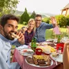 A group of friends enjoying a barbecue outdoors. Produktbild-Vorschau