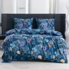 A neatly made bed with a floral patterned duvet and pillows. Anteprima dell’immagine prodotto