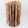 A cylindrical bundle of wooden stakes bound together with wire. Voir les images du produit