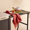 An outdoor serving cart with food and dishes on it. Produktbild-Vorschau