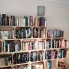 A wall filled with wooden crates stacked and filled with books. Náhled obrázku produktu