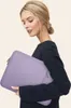 A woman holding a laptop sleeve. Náhled obrázku produktu