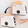 A toy toaster with pop-up toasts, with a hand pressing the lever. Anteprima dell’immagine prodotto