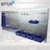 A metal pegboard tool organizer with various hooks, holders, and bins, displayed on a workbench. Produktbild-Vorschau
