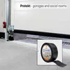 A roll of black tape is shown in a close-up inset, with a white garage door and concrete floor in the background. Anteprima dell’immagine prodotto