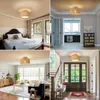 A collage of four images showing a rattan ceiling light fixture in different home settings: a bedroom, a hallway leading to a kitchen, a living room, and an entryway with a staircase. Produktbild-Vorschau