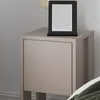 A modern nightstand with an e-reader on top. Produktbild-Vorschau