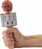 A hand holding a pink karaoke microphone. Podgląd zdjęcia produktu