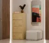 A modern hallway with a wooden cabinet, a mirror with abstract art, and an ottoman. Anteprima dell’immagine prodotto