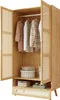 An open wooden wardrobe with clothes hanging inside and storage boxes on shelves. Anteprima dell’immagine prodotto