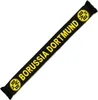 A black and yellow Borussia Dortmund scarf is laid out diagonally on a white background. Podgląd zdjęcia produktu