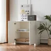 A white cabinet with its doors open, displaying shelves with books and folded blankets. A lamp and a speaker are on top of the cabinet. Produktbild-Vorschau