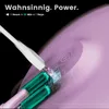 Close-up of a purple electric toothbrush being charged, with a white charging cable plugged in. The toothbrush has green brush heads visible. Text overlays highlight its power and battery life. Podgląd zdjęcia produktu