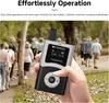 A hand holding a Retekess transmitter with a group of people walking in the background. Náhled obrázku produktu