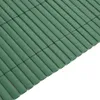 A close-up, angled view of a green PVC garden fence. Anteprima dell’immagine prodotto