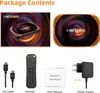 A collage of images showing the contents of a product package, including the device, remote, cables, manual, and power supply. Náhled obrázku produktu