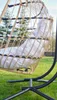 A hanging chair with a cushion is placed on a lawn. Podgląd zdjęcia produktu