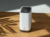 A white eufy security device sits on a wooden surface with a shadow of palm leaves cast on the left side. Náhľad obrázku produktu