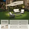 A patio set with a large umbrella illuminated by LED lights, set up on a lawn at night. Náhled obrázku produktu