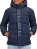 A young person wearing a blue puffer jacket. Produktbild-Vorschau