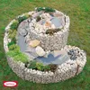 A spiral herb garden made of gabion baskets filled with stones and plants, set in a grassy garden. Produktbild-Vorschau