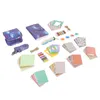 A collection of accessories for an instant camera, including a camera case, a notebook, decorative papers, and other small items, arranged on a white background. Náhled obrázku produktu