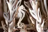 A close-up view of a wooden seahorse model surrounded by decorative wooden elements, possibly part of a 3D puzzle. Podgląd zdjęcia produktu