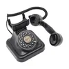 A black retro rotary dial telephone with its handset off the hook, isolated on a white background. Podgląd zdjęcia produktu