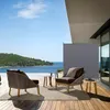 An outdoor patio with furniture and a view of the ocean. Anteprima dell’immagine prodotto