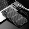 A black phone case with a carbon fiber look is placed on a laptop keyboard, with two pens nearby. Produktbild-Vorschau