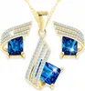 Ensemble collier en or avec cristal bleu et boucles Voir les images du produit 1