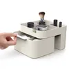 A hand is shown pulling out a drawer from a cosmetic organizer. Náhled obrázku produktu