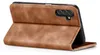 A brown flip cover case for a smartphone is shown open, revealing the camera module of the phone. Produktbild-Vorschau