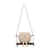 A decorative planter pot shaped like a cartoon character sitting on a swing. Anteprima dell’immagine prodotto