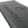 A close-up of a black foam seat cushion with embossed text and a logo. Produktbild-Vorschau