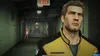 A man in a yellow and black jacket stands in the foreground, looking to the right. In the background, a hallway with an "EXIT" sign and a woman in a light-colored dress are visible. Produktbild-Vorschau