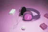 A pair of pink and purple Philips headphones are placed on a purple surface, surrounded by toy building blocks. Produktbild-Vorschau