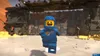 A LEGO spaceman character stands in front of a large, industrial-looking structure made of LEGO bricks. Náhled obrázku produktu