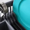 A close-up view of a dish rack with a teal plate and silverware. Produktbild-Vorschau