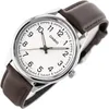 A close-up shot of a Casio watch with a white face and a brown leather strap, set against a white background. Produktbild-Vorschau