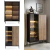 A collage of images showcasing a modern vitrine cabinet with glass doors and wooden slatted fronts, illuminated by LED lighting. Produktbild-Vorschau