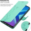 A close-up view of a turquoise flip phone case with a floral pattern, showing the magnetic closure feature. Náhled obrázku produktu